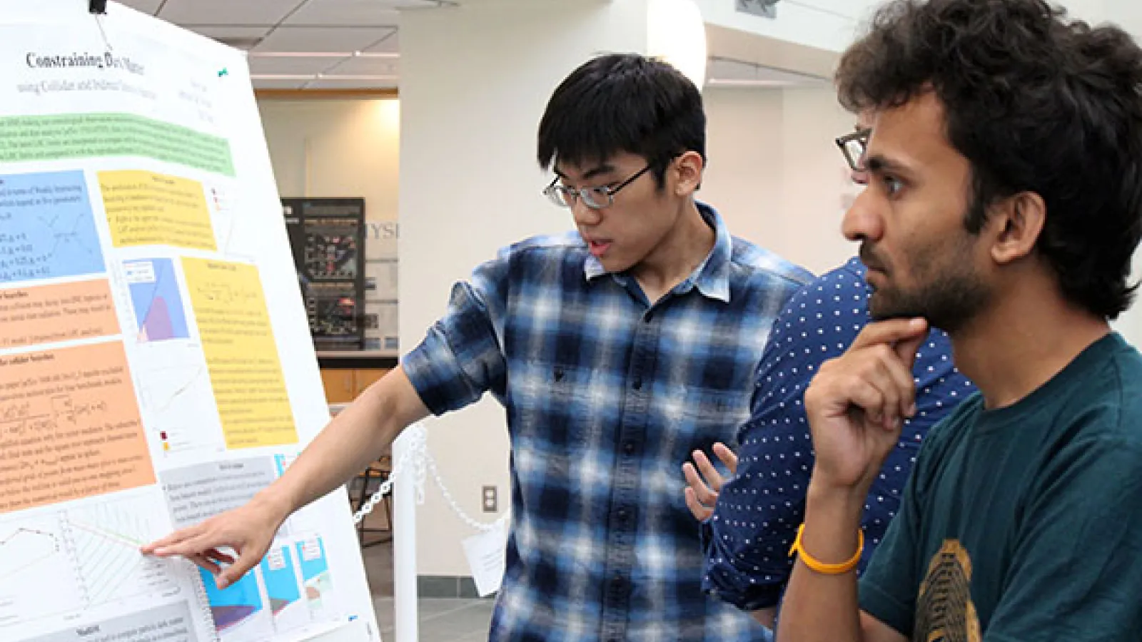 student and judges next to poster