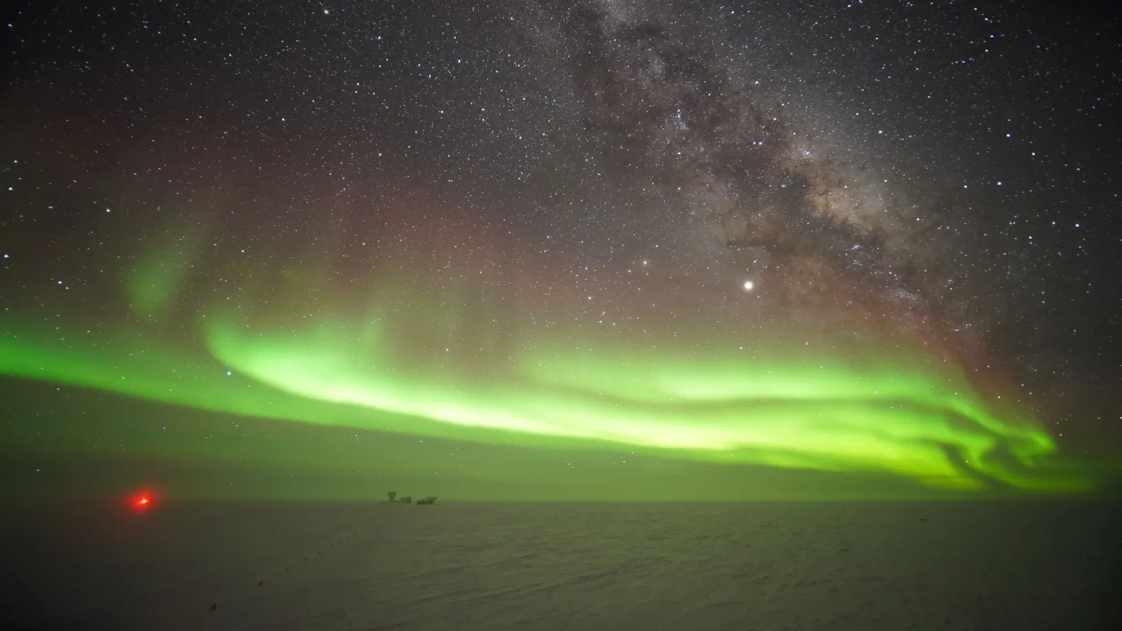 Green aurora borealis in the distant sky