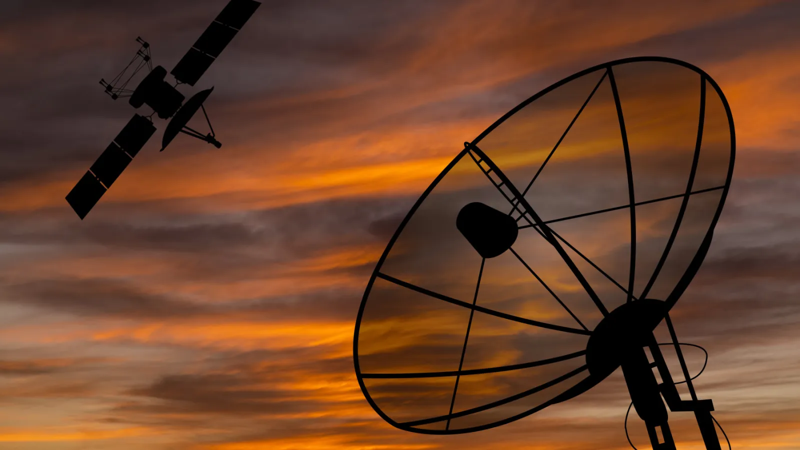 Large antenna and satellite with sunset in the background