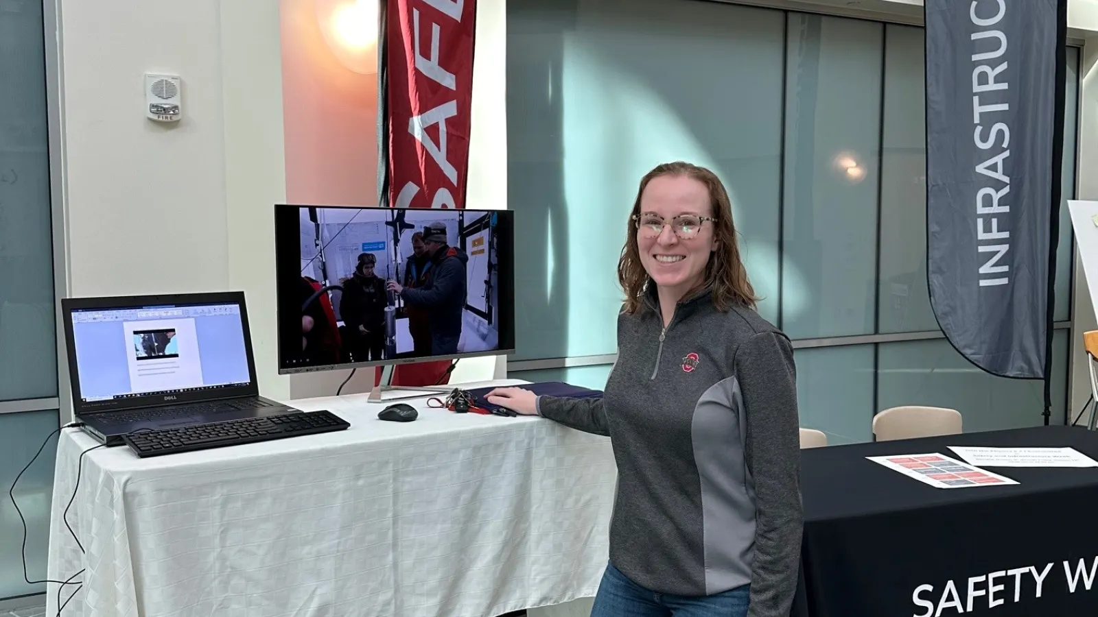 Kaeli Hughes at Safety and Infrastructure tables in the Atrium