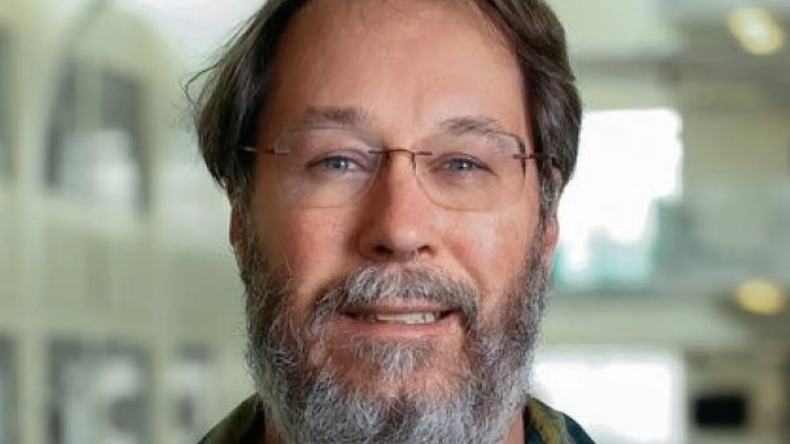 Professor Beatty smiling with PRB atrium in the background