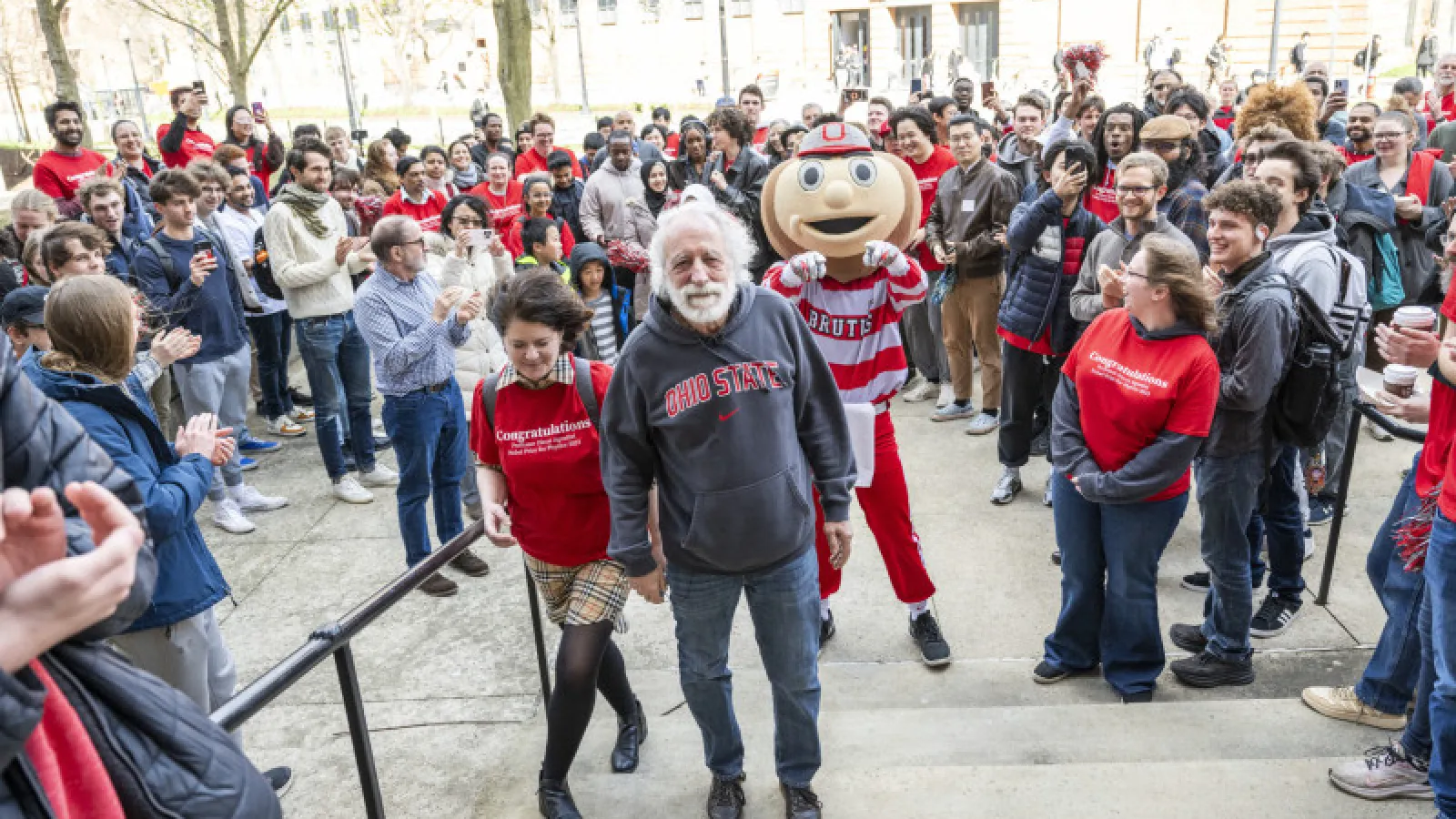 Pierre Agostini in front of a crowd, walking up the north steps of the PRB.