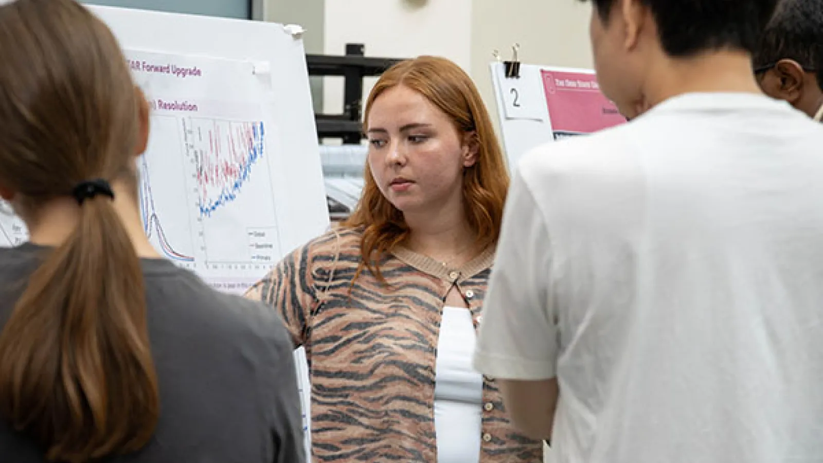 Student presenting a research poster during a poster session