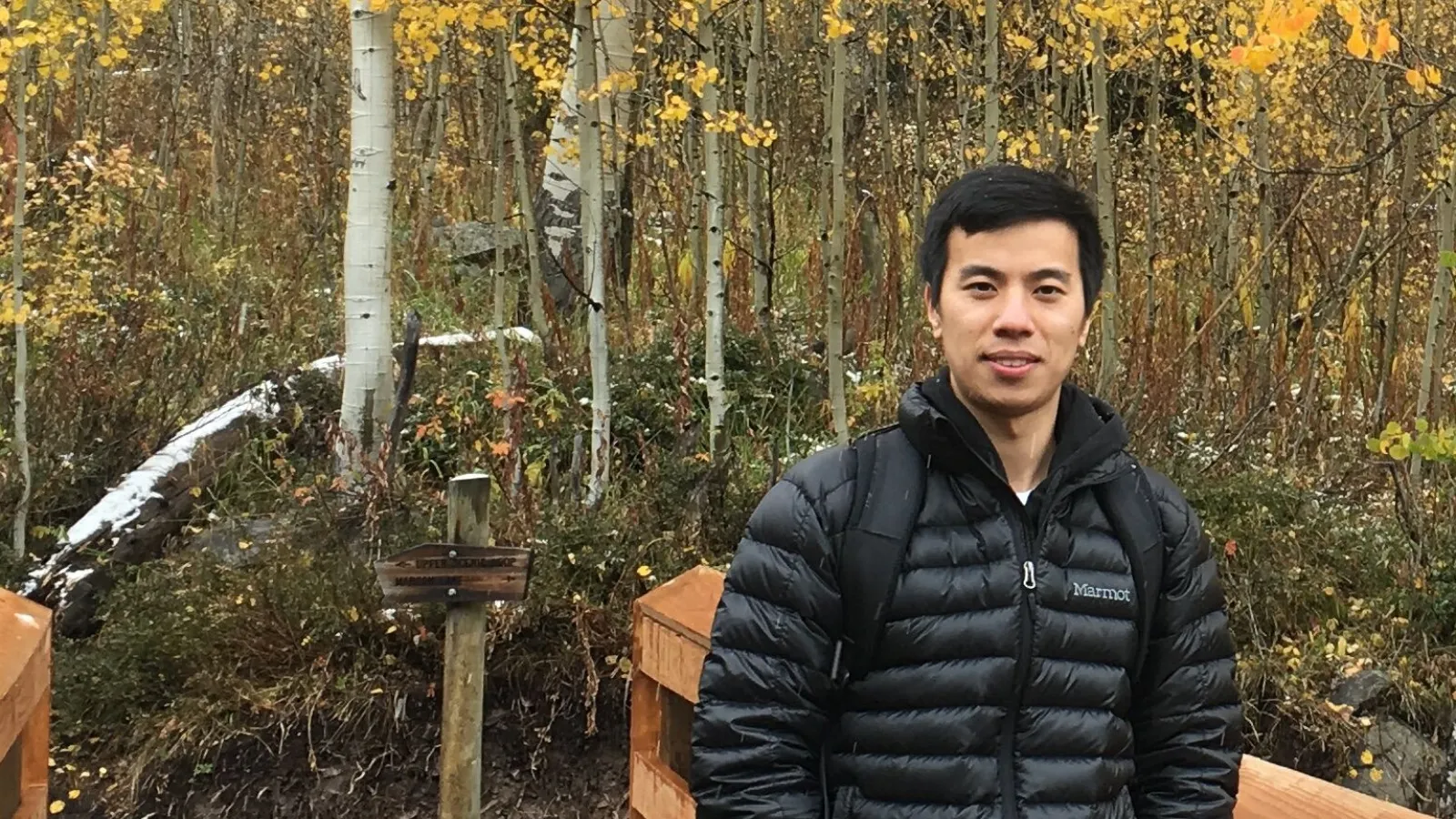 zhu smiling in front of trees