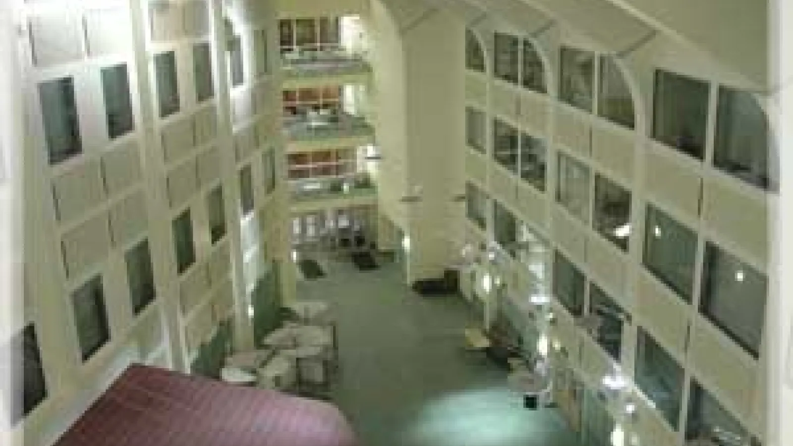 The interior of the Physics Research Building atrium. On each wall, there are glass windows to offices.