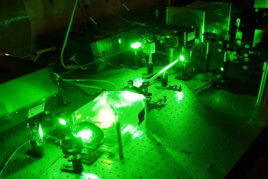 Machine in a dark room glowing bright green