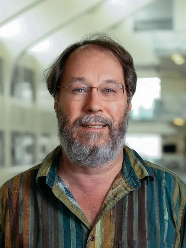 Professor Beatty smiling with PRB atrium in the background