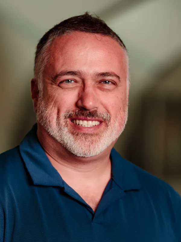 Headshot of Johnston-Halperin smiling with blurred out PRB in the background