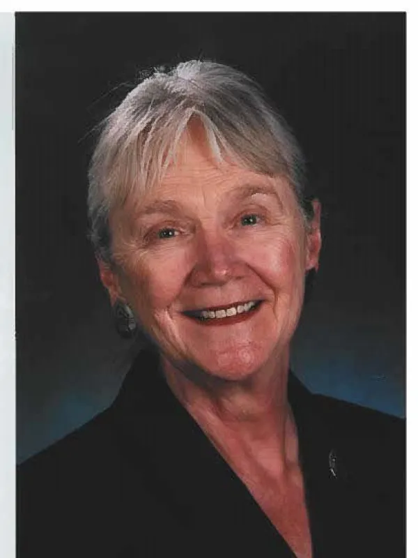 Bunny Clark smiling with dark blue and black background