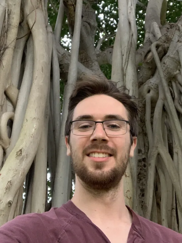 Ethan Doerstling in front of a banyan tree in Hawai'i