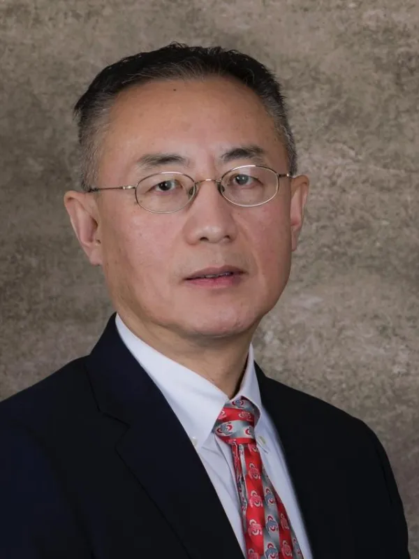 Close up of Ray Cao with a brown background