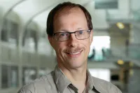 Professional headshot; Ralf Smiling